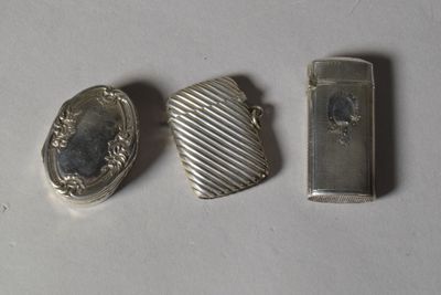 trois objets en argent posés les uns à côté des autres sur une table