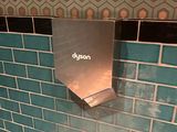 des toilettes dans une salle de bains dont le mur est carrelé de bleu
