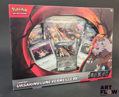 une photo d'une boîte de cartes Pokémon posée sur une table