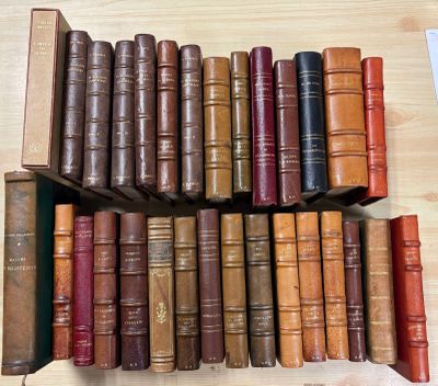 a lot of old books on a shelf on the table