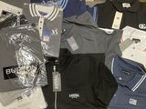 a lot of men ' s polo shirts that are on a table