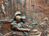 a close up of a bronze relief of a woman and a man