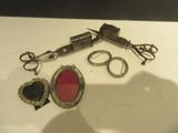 a pair of scissors, a pair of glasses, and a pair of scissors on a table