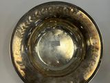 an antique silver plate on a white table with a white background