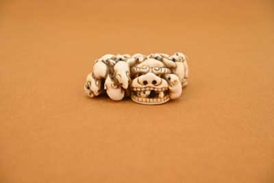 an image of a group of skulls sitting on top of a brown surface