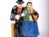 a figurine of a man and a woman sitting on a bench