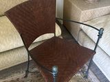 a brown chair sitting in a living room next to a couch
