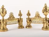 three golden vases sitting on a bench next to each other