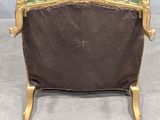 a green and gold chair with a green cushion on it