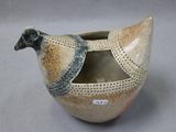a bird shaped vase sitting on a table