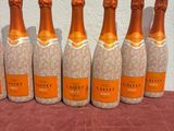 six bottles of champagne are lined up on a table