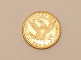 an image of a gold coin on a white surface