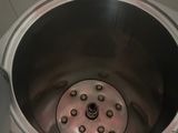 a large metal bowl with a drain inside of it