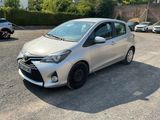the silver toyota yaris is parked in a parking lot
