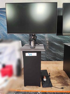 two monitors and a keyboard on a table