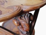 a close up of a wooden table with carvings on it