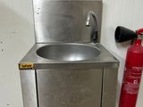 a fire extinguisher next to a sink and a fire extinguisher