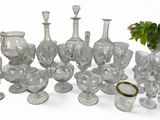 a lot of glass vases and glasses on the table