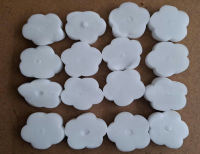many white buttons that are on a brown surface