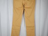 a pair of yellow pants hanging on a white curtain