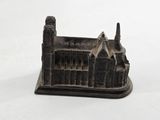 a small statue of a building with a clock on it