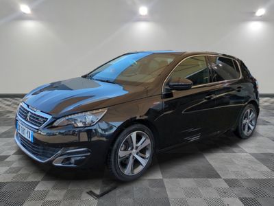 a black car is parked in a room with a checkered floor