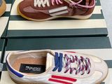 pair of pucci sneakers in boxes on a table in front of a cardboard box