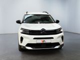 the front view of a white citrole parked in a white room