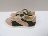 pink and black sneakers with white soles on a white surface