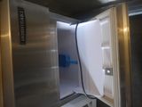a refrigerator with a door open in a kitchen