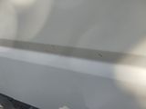 a close up of a white boat with a hole in the side