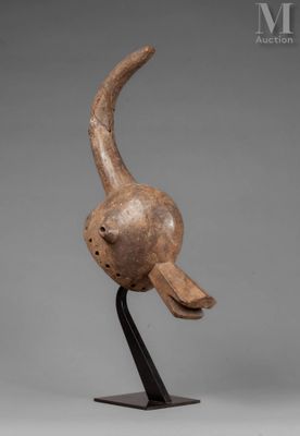 a wooden sculpture of a bird on a black stand