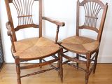 two wooden chairs sitting next to each other on a hard wood floor