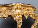 a gold table with a marble top on it