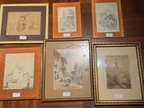 a lot of framed art on the floor of this room