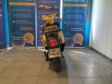 a scooter that is parked in front of a wall