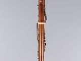 a clarinet with a wooden body and brass handles
