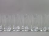 a lot of glasses that are lined up on the table