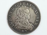 une vieille pièce d'argent sur laquelle figure la tête d'une femme coiffée d'une couronne
