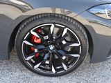 the wheels of a bmw car are black with red spokes