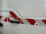 a white van with a red and white stripe on the side of it