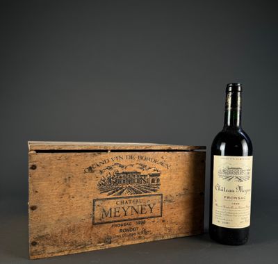a bottle of wine sitting next to a wooden box on a table