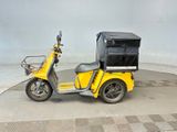 a yellow motorcycle with a black cover on the back