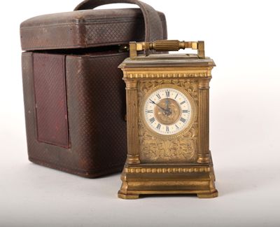 a small clock that is sitting next to a box