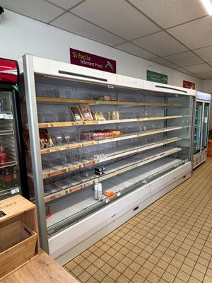 a large display case in the middle of a grocery store