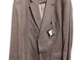 the suit is hanging on a hanger on a white wall