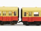yellow and red train cars on a white surface with a white background