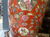 a large vase sitting on a table in front of a window