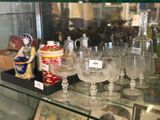 a glass case with a lot of wine glasses on it