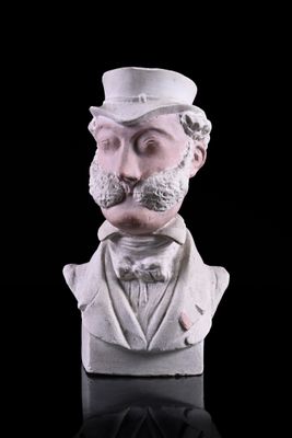 a bust of a man with a mustache and a top hat